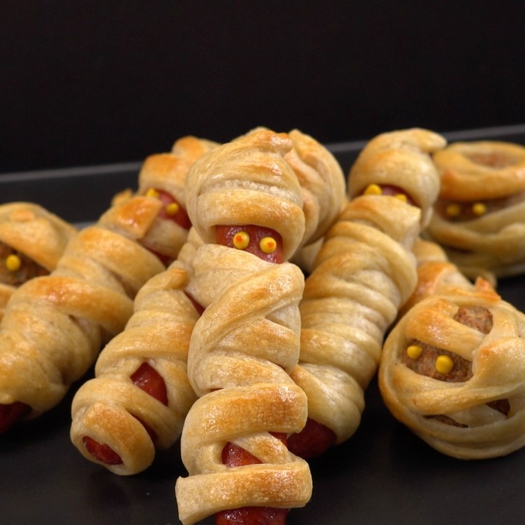 Hot dogs and meatball wrapped in dough to look like mummies
